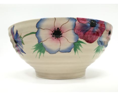 A Clarice Cliff pottery bowl of rimmed form decorated in the Anemone pattern, Wilkinson marks, shape, (24cm)