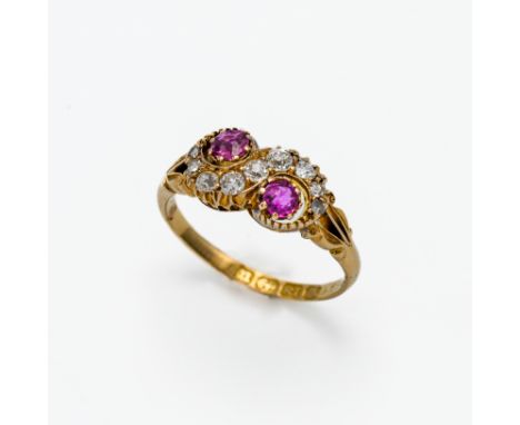 An 18ct diamond and ruby swirl ring, size J.