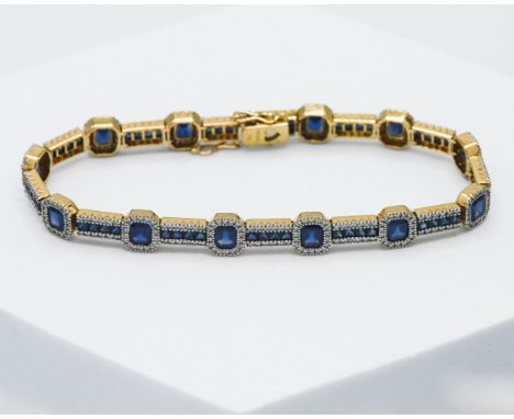 An 18ct yellow gold bracelet set with twelve step cut sapphires and fifty-two square cut sapphires, total sapphire weight app