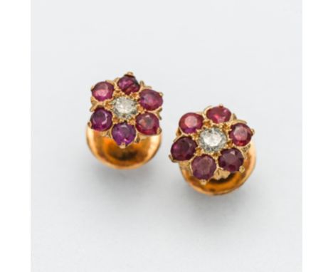 A pair of diamond and ruby flower studs on screw back fitting (not hallmarked).