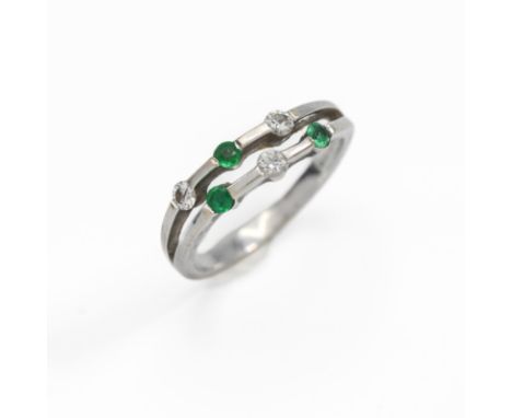 An 18ct white gold double row ring set with three round cut emeralds &amp; three round brilliant cut diamonds, 3.37gm, size M