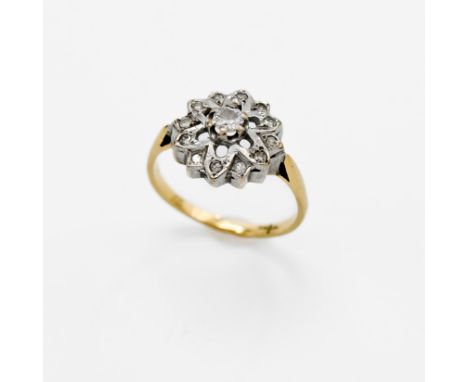 An 18ct yellow gold &amp; platinum flower cluster ring set with small round cut diamonds, 3.34gm, size M.