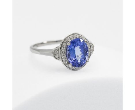 A platinum ring set with a 2.69 carat oval cut AAA Tanzanite, surrounded by 0.16 carats of diamonds, 5.04gm, size R to S, by 