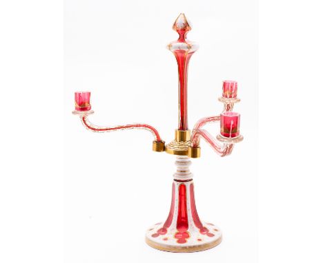 A Bohemian overlay glass three-branch candelabra in white, ruby and clear glass, on flared and fluted base, 19th century, 41c
