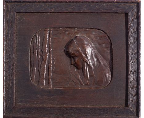 A Continental patinated bronze plaquette, circa 1900; portraying a girl, bust length and wearing a shawl, amongst trees, with
