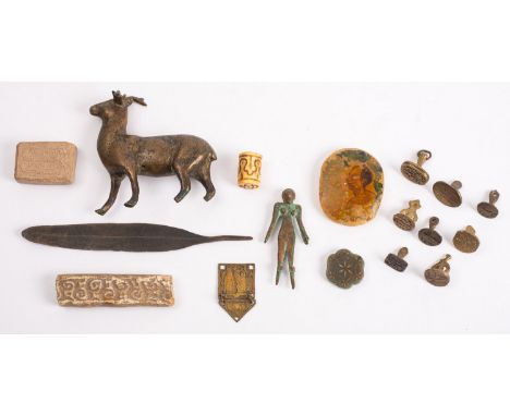 A mixed lot of small Islamic works of art including eight engraved brass seals, a painted stone pendant, a carved jade rosett