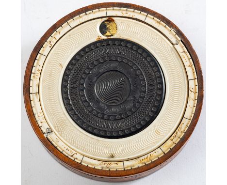 A burr walnut and Holtzapffel lathe turned ivory snuff box, early 19th century; the cover with inset moveable dial with apert