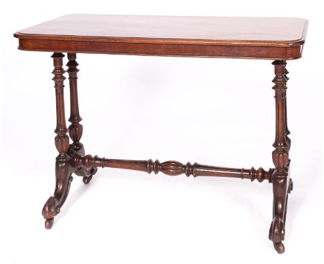 A Victorian mahogany side table, mid 19th century; the rectangular top with moulded edges, on four fluted and lobed supports 