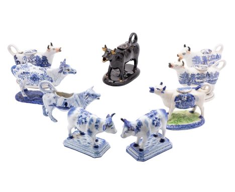 A group of nine 19th/20th century English and Continental ceramic cow creamers comprising four Staffordshire Willow pattern c