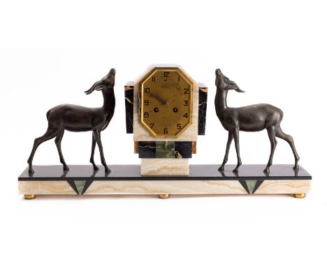 A French Art Deco marble mantel clock with opposing figures of deer, the eight-day duration movement stamped to the rear with