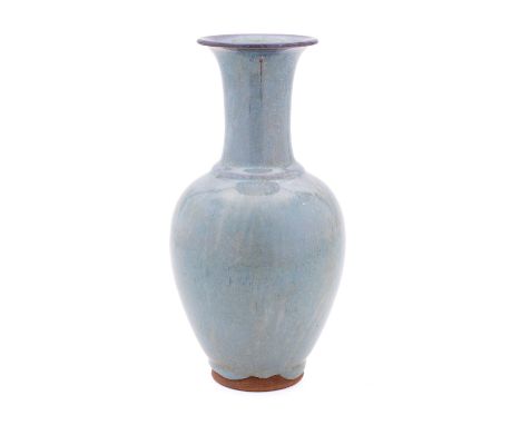 A Chinese pottery vase of oviform with raised slender neck and under a pale blue glaze with lavender tinged rim, 24cm high.