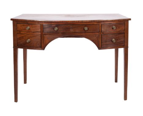 A Regency mahogany and line inlaid bowfront sideboard, early 19th century; with an arrangement of four drawers around a shall