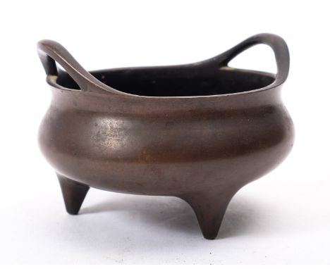 A small Chinese bronze tripod censer with loop handles and short tapering feet, apocryphal Xuande seal mark, 12cm.