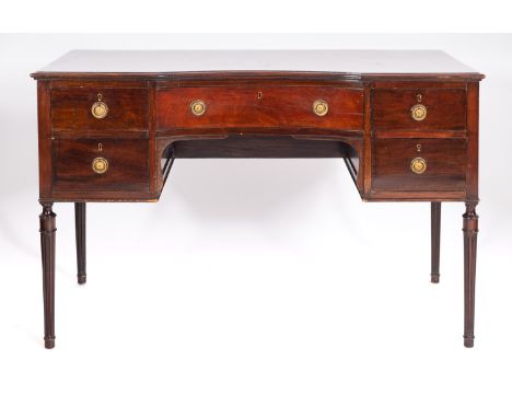A mahogany dressing table in Regency taste, 20th century; the top with moulded edges and concave front; with five drawers aro