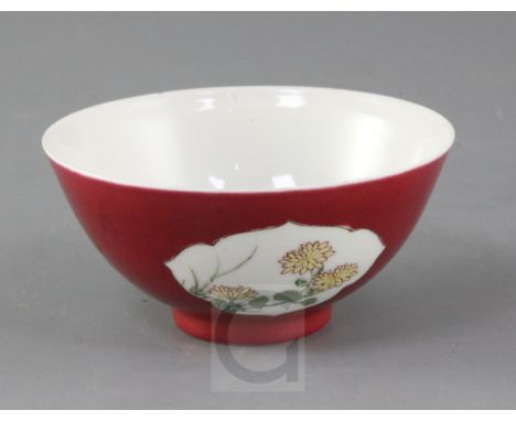 A Chinese ruby backed famille rose bowl, early Qianlong period, the interior painted with a sprig of peonies and pomegranates