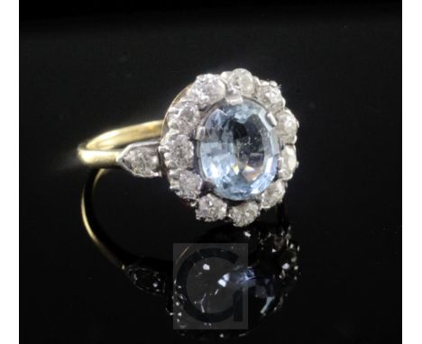 A mid 20th century aquamarine and diamond oval cluster ring, size M.