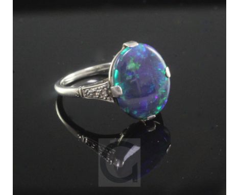 A 1940's 18ct white gold, platinum and black opal ring with diamond set shoulders, size M.