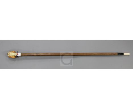 An Italian Art Nouveau walking stick, with paste inset Salvine porcelain woman's head handle, and squared shaft, 35in.