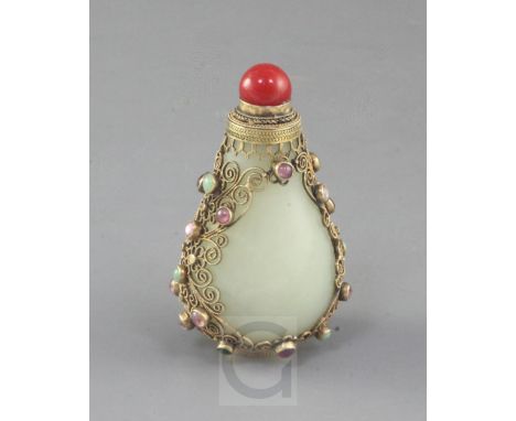 A Chinese pale celadon jade, silver gilt and cabochon gem mounted snuff bottle, early 20th century, the pear shaped jade bott