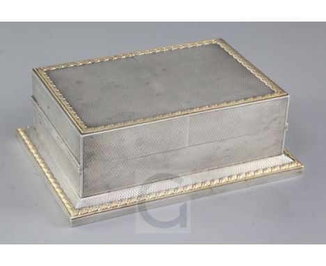 A good George V engine turned parcel gilt silver double lidded rectangular playing card box by Asprey & Co Ltd, with foliate 