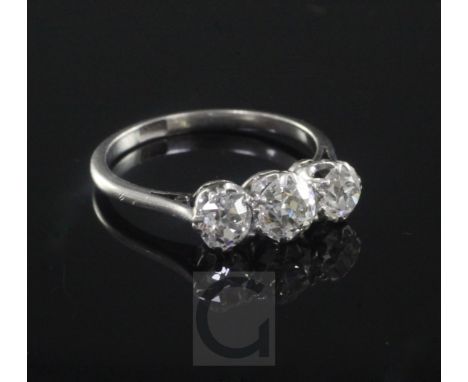 A 1930's/1940's platinum and three stone diamond ring, the three old round cut stones with an estimated total weight of 1.25c