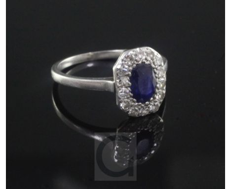 A 1920's/1930's platinum?, sapphire and diamond oval cluster ring, size M.