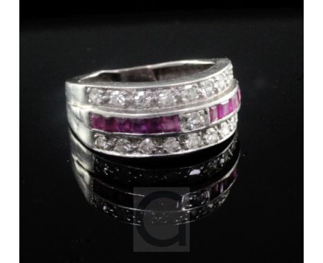 A 1940's white gold, diamond and channel set ruby triple band ring, shank a.f., size approx. K.