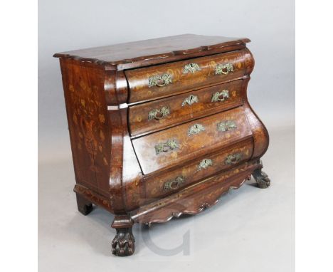A 19th century Dutch walnut and marquetry double bombé commode, the top inlaid with flowers in a basket, fitted four long dra