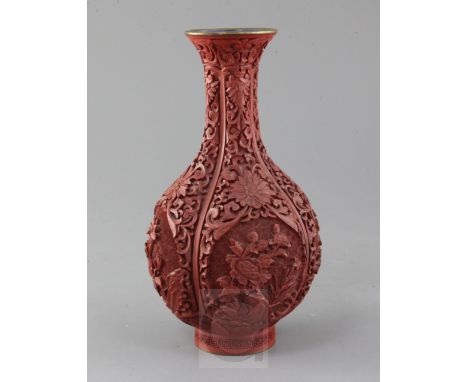 A Chinese cinnabar lacquer bottle vase, first half 20th century, carved in high relief with flowers and rockwork, lotus flowe