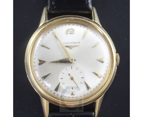 A gentleman's 1950's 18ct gold Longines manual wind wrist watch, with arrowhead markers and subsidiary seconds, on associated