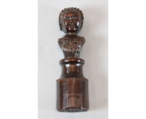 A 17th century carved oak newel post finial of a woman, on circular plinth, 11in.