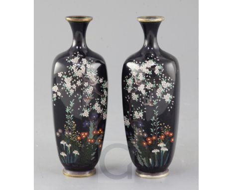 A pair of Japanese silver wire cloisonne enamel hexagonal vases, Meiji period, decorated with birds amid flowers, on a midnig