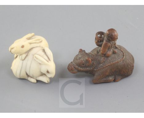 Two Japanese netsuke, 19th century, the first carved in ivory of two hares with horn or amber inset eyes, 2.6cm, the second c