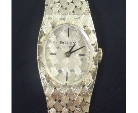 A lady's 14ct gold Rolex manual wind wrist watch, the oval dial with quarterly baton markers, on integral 14ct gold Rolex bra