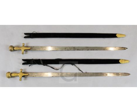 A near pair of Indian sword tulwars, late 19th century, each having gilt copper hilt with incised decoration en suite with th