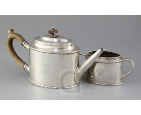 A George V silver oval teapot and matching sugar bowl engraved with latin motto 'Make For The Shore' above a ship, G.W. Aldri