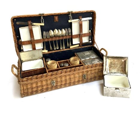 A vintage wicker picnic hamper, with fitted interior with contents, including four ceramic lined tin boxes; cutlery; tin and 