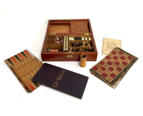 A 19th century mahogany cased compendium of games to include chess and backgammon boards and pieces; dominoes; cribbage; vari