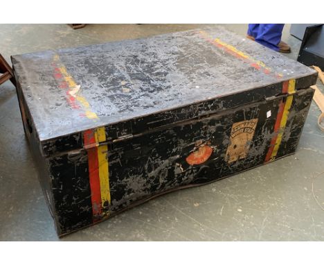A metal travel trunk with hinged lid and travel stickers, double red and yellow stripe, 89x54x33cm 