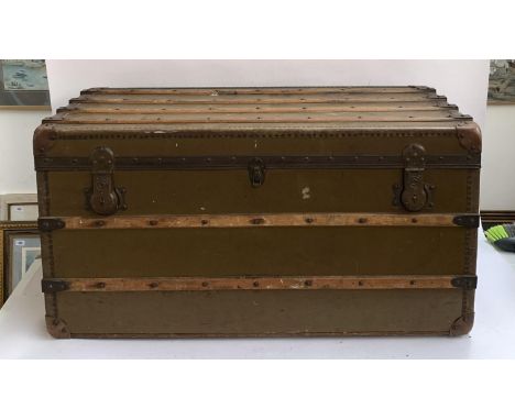 A large canvas and wood banded travel trunk by Ernst Ott, Wien V Castelig, handles af, leather corners, 101x54x51 