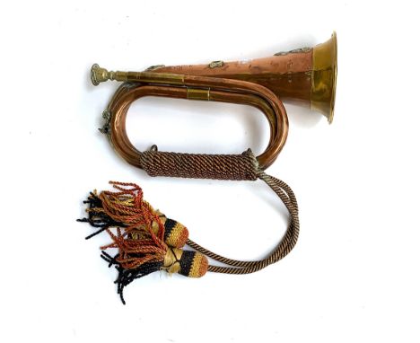 A military copper and brass bugle, bearing the crest of the XII Royal Lancers, and name plate for 628 Bugler, L. Edwards 