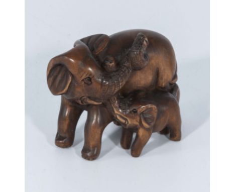 Hand carved hardwood netsuke of elephants 