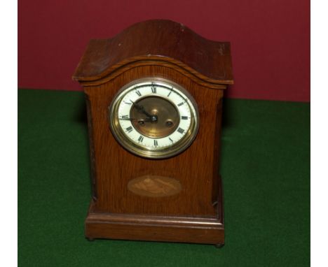 An Edwardian oak mantle clock.
