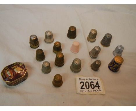 A quantity of old thimbles including an enamel example and an enamel pill box.