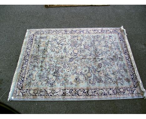 A light blue floral/ nature patterned rug. Length 245cm x 170cm. COLLECT ONLY.