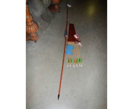 An English solid bamboo long bow, 30lb at 28" draw, with arrows, case, finger tab and arm protector.&nbsp; Made by local craf