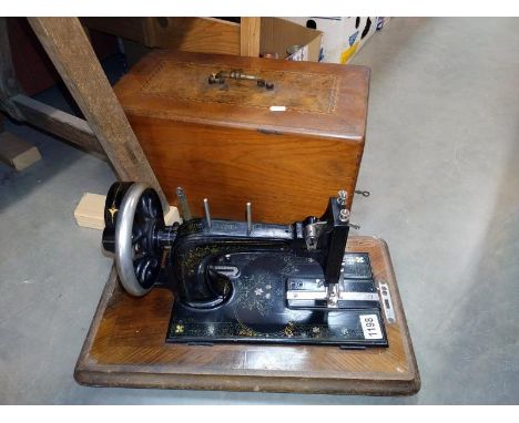 A vintage Frister Rossmann sewing machine in an inlaid box.