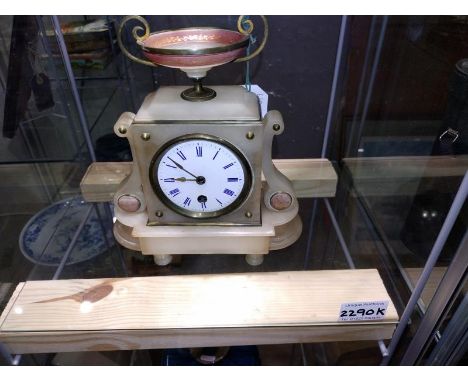 A 19th Century alabaster mantel clock, enamel dial, surmounted with an urn.&nbsp;COLLECT ONLY.