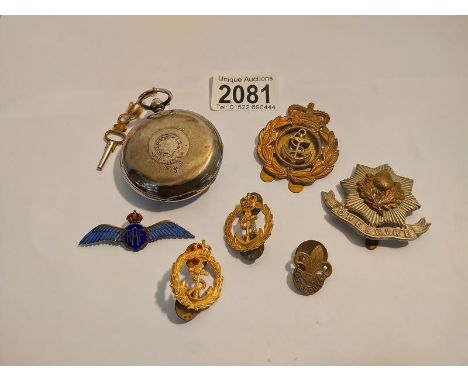 A silver hunter pocket watch A/F. A quantity of military cap badge including silver enamel RAF wings and pin badges. 