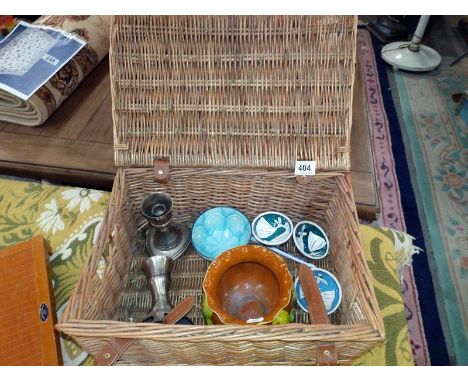 A basket of miscellaneous, including silver plated candlesticks, art nouveau pottery planter